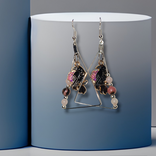 crow handmade crystal earrings with rose quartz and rhodonite for halloween.